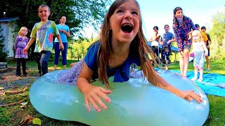 Slow motion belly flops on a Giant Water Balloon! | 6 foot Climb inside balloon filled with water