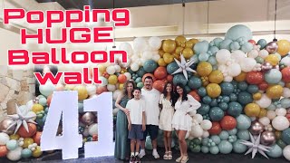 Popping balloons of this HUGE balloon wall