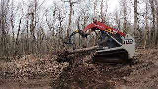 Log grapple on a compact track loader