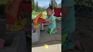 Cute 3 Year Old Girl Playing In The Sandbox