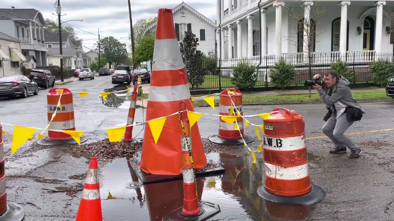 An approximately 8-foot-tall traffic cone has appeared at the intersection ...
