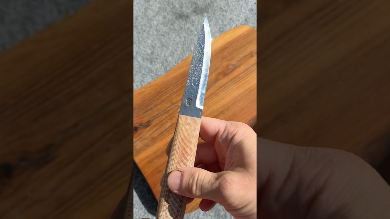 Modern puukko with handforged blade and natural canvas micarta handle. It’s for sale.