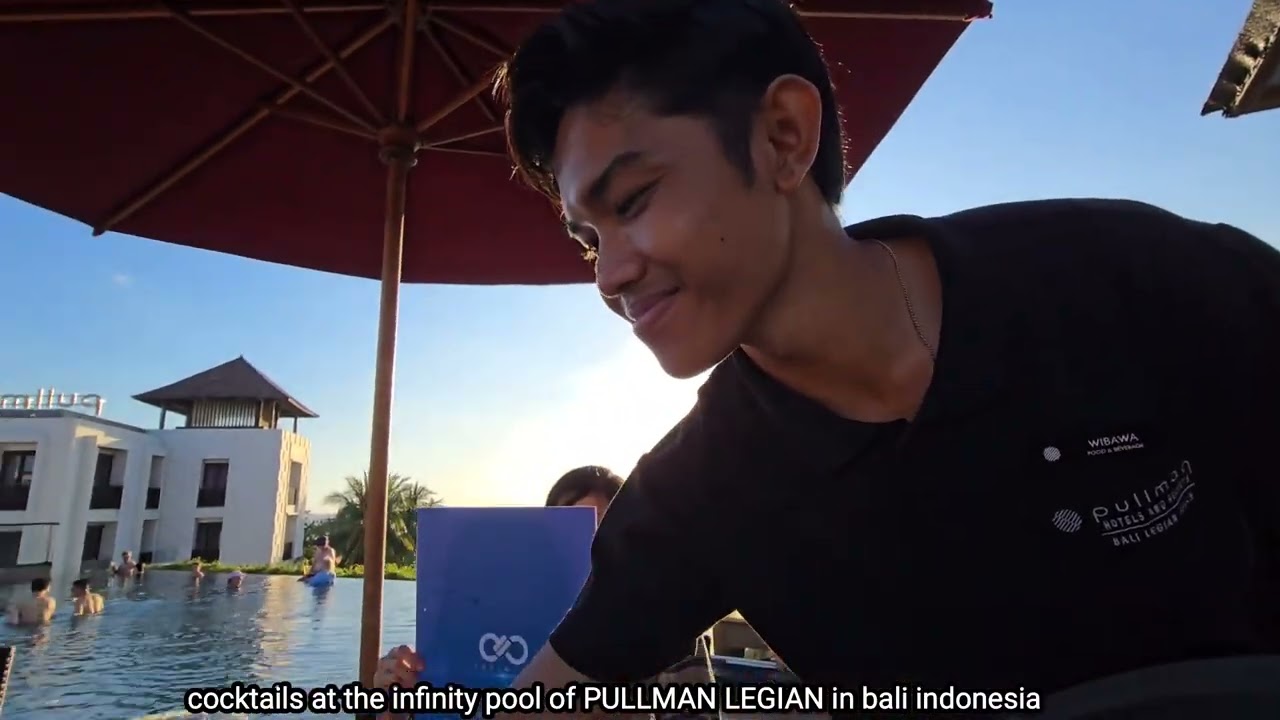 sunset cocktails at the infinity pool of the PULLMAN LEGIAN in bali indonesia.