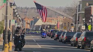 Officers, public line streets of Waltham during procession for Officer Paul Tracey