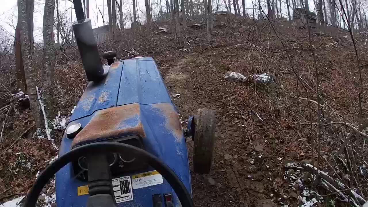 Pulling out a downed tree from the new road! Farmtrac and grapple - YouTube