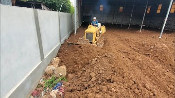 LANDFILL in fence use soil work by Mitsubishi bulldozer pushing soil with dump truck uploading soil 