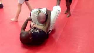 Coach Becks demonstrating a triangle choke from guard.