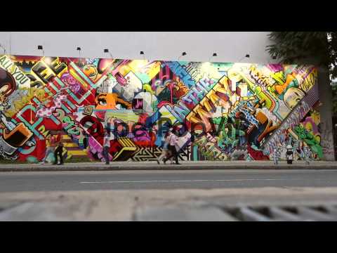 Extreme long shot. People walk past the new street mural ...