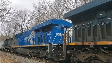 CSX M372 with 1976 Conrail heritage unit, a GP38-3, Wisconsin central boxcar and a SOO Centerbeam
