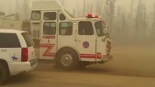 Raw: Syncrude trucks speeding towards Fort McMurray wildfire
