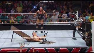 Ryback powerbombs Daniel Bryan through table