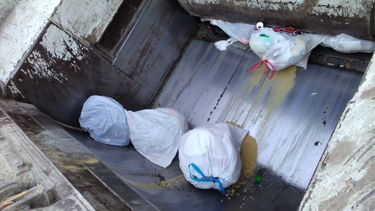 Trash Truck Hopper View bags popping and crushing