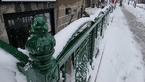 Removing Snow From Beautiful Green Basement Security Rail