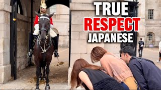 Japanese Family Shows Respect And Bows To The Kings Guard And Horses