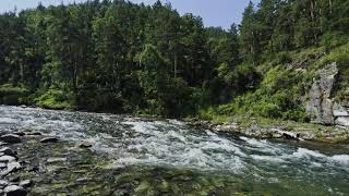 The sound of a beautiful mountain river flowing. Relaxing sounds of nature. 4K VIDEO.