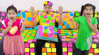 suri and sarah pretend play with colored sticky tape notes