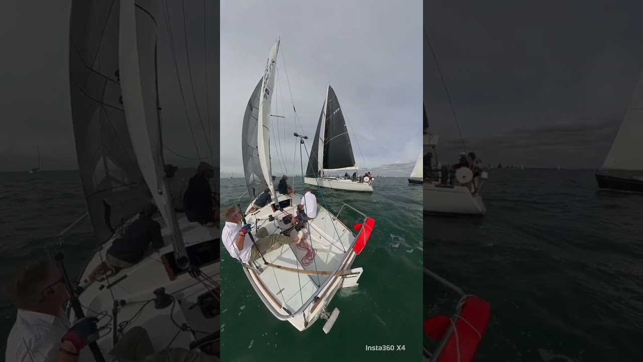 J24 sailing.  port tack start on big boat start line.