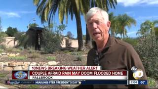 Couple afraid rain may doom flooded home