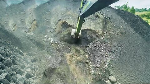 Barge unloading 4800 tons of ore - excavator working on barge