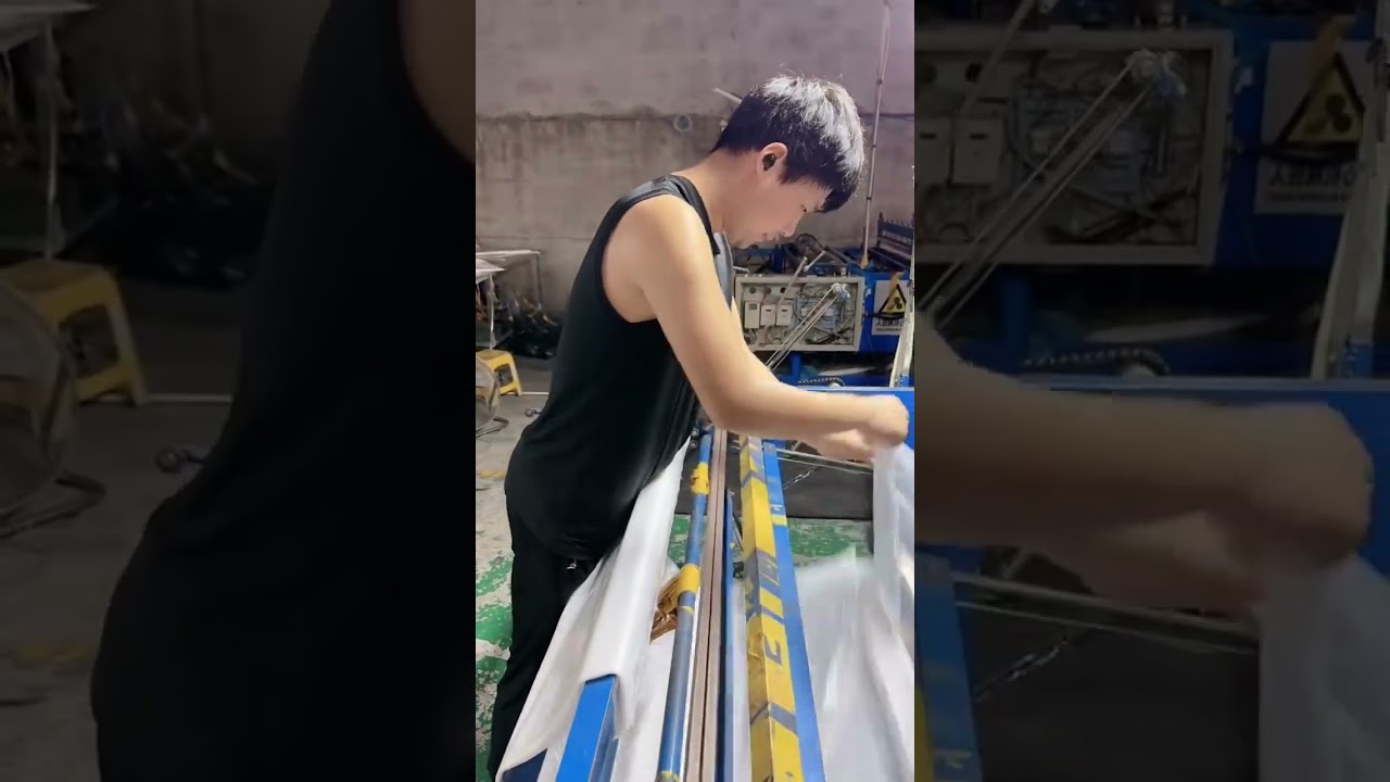 Sealing the side seams of plastic bags using a heat sealer. 