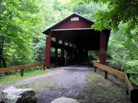 Growing up in Pennsylvania means that Covered Bridges are part of every day life: Charming and useful, all different, and a reminder of forgotten days. I walk or drive over a covered bridge nearly every day. My idea for this video was to give those unfamiliar with these wonderful structures a glimpse. I could only show a small sampling of covered bridges here in Pennsylvania, and of course, there are many surviving covered bridges in other states. Most of the bridges are identified in the video. Some that are not: at 1:40 is Greisemer Mill Covered Bridge built 1832, north of Yellow House in Berks County; at 4:28 is Pool Forge Covered Bridge, built 1859, west of Churchtown in Lancaster County; the second to the last photo is the Kennedy Covered Bridge, north of Kimberton on Seven Stars Road, built in 1866. It burned down in 1986, and a replica was built in 1988. The last photo is of the famous Knox Covered Bridge over Valley Creek in Valley Forge, built in 1865, restored in 1996 (both in Chester County). These bridges are all examples of the Burr Arch Truss design, invented in 1804 by Theodore Burr. The first US covered bridge was located in Philadelphia over the Schuylkill River at 30th Street and built in 1800 by Timothy Palmer, a master carpenter from Newburyport, Massachusetts. The investors asked to have it covered in the hopes of extending the life of the bridge. And the covered bridge era began. Since the heyday of the covered bridge in the 1800s they have been <b>...</b>