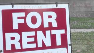 House For Rent Sign in Classic Template on Lawn of Suburban Home in Daytime | HD Stock Video Footage