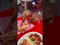 Two roosters stealing our Cuban sandwich. in ybor city Florida near Tampa.