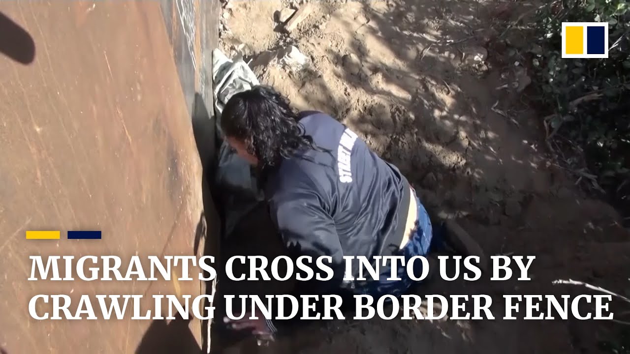 Migrants cross into US by crawling under border fence - YouTube