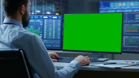 Stock Market Trader Working on a Computer with Isolated Mock-up Green Screen | Stock Footage -