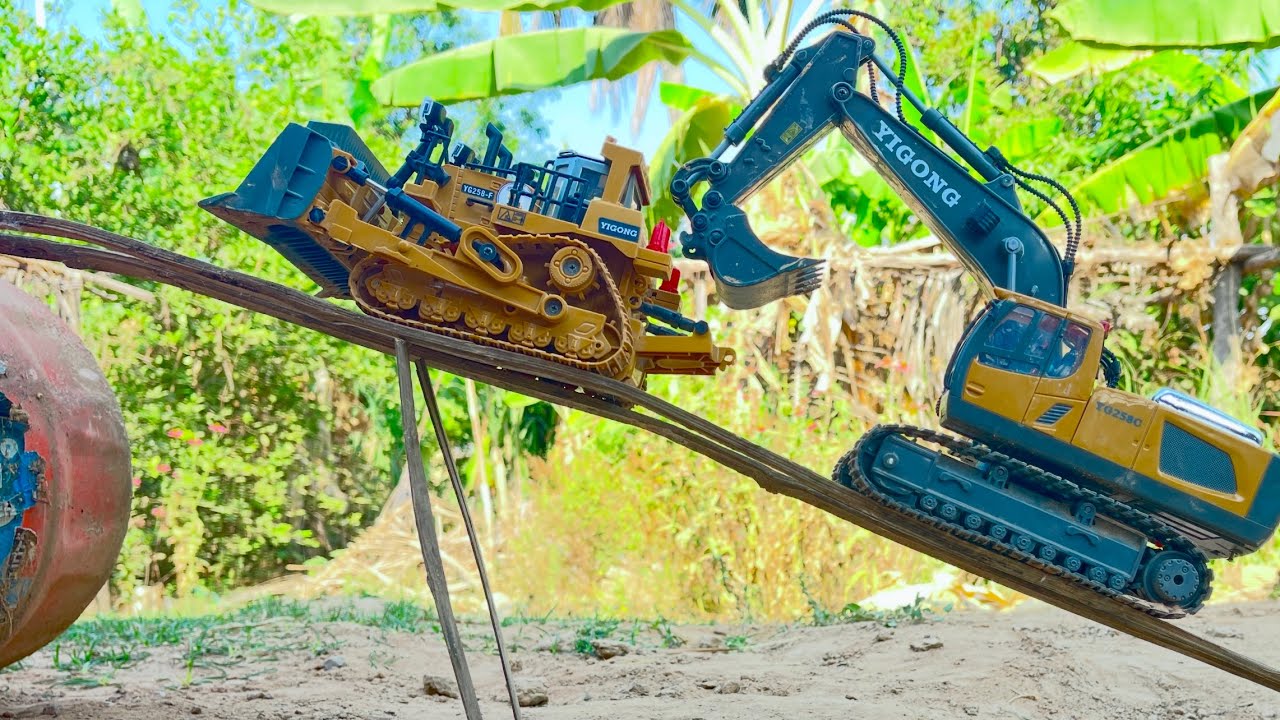 An excavator climbs a small bridge.