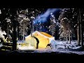 Glowing hot tent winter camping  cut wood make fire cook food