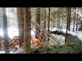 Building primitive shelter in winter forest outdoor cooking survival skills nodya campfire