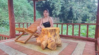 Girl makes wooden tables and chairs combined with tree stumps to make tables