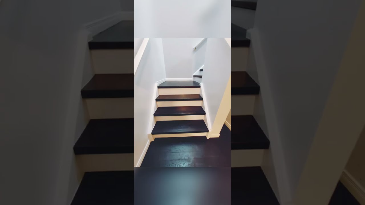 Experience the Bold Beauty of Dark Hardwood Flooring with High Contrast Piano Stairs