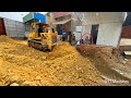 Full action  first session building new foundation village road by trucks  dozer spreading stone