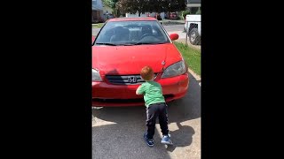 Kid Pushing The Car Down The Driveway