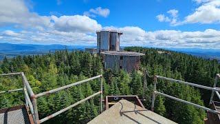 Abandoned Mountain Top Military Base Crumbling Rusting. Big Tanks And Flooded Road