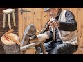 Old style carpenter makes oak stool with hand tools