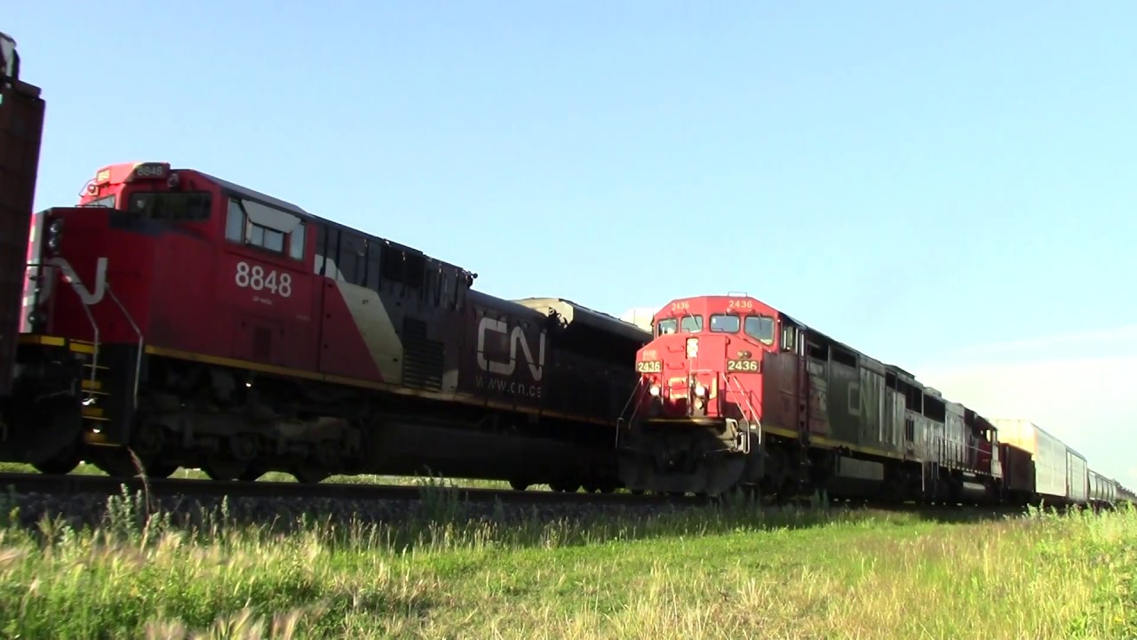 CN SD70m2 idling, waits for approaching freight