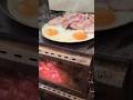 Sizzling bacon and eggs cooked on the woodstove in the hot tent. #hottent #campandcook #baconandeggs