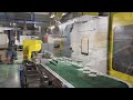 Automation packaging system for pudding cups.