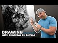 Drawing a bison with charcoal on canvas