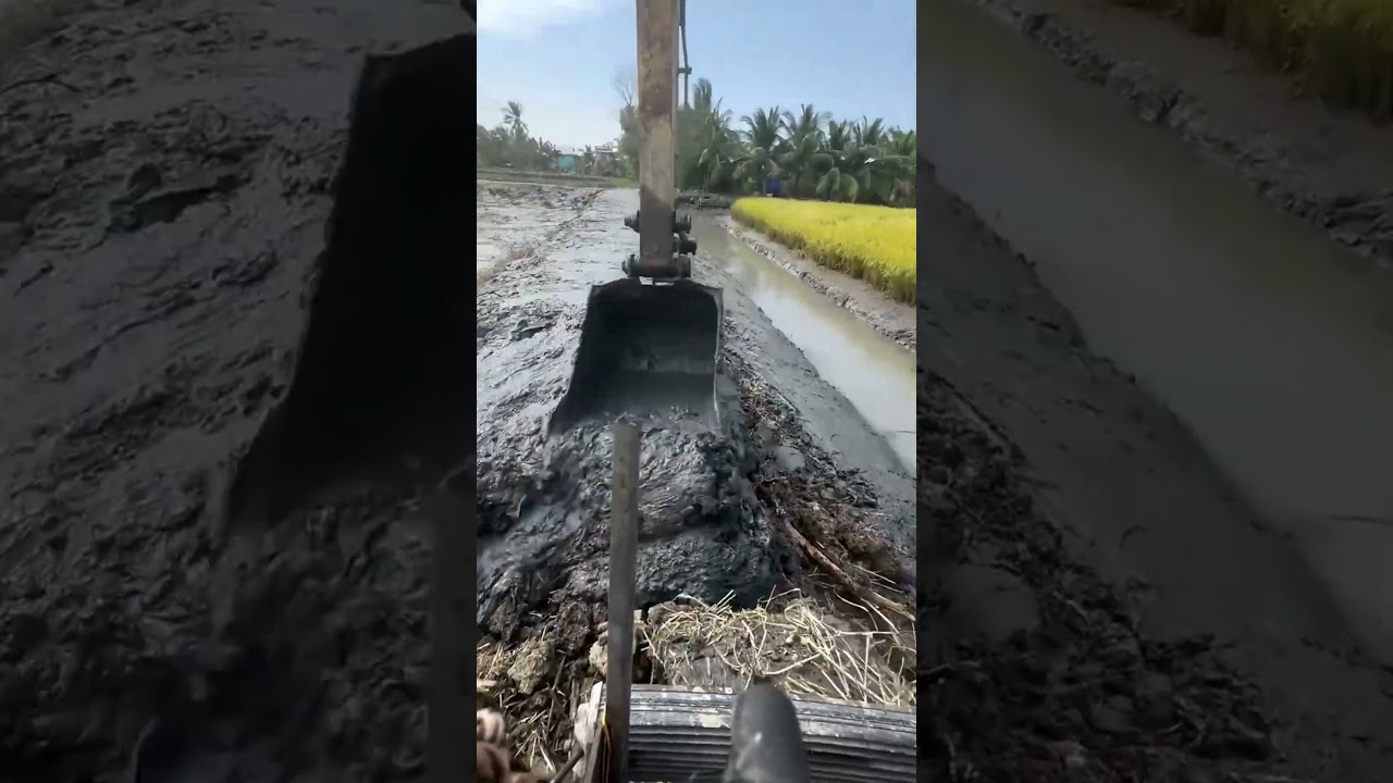Excavator clears river silt
