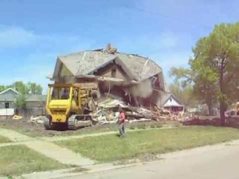 A once-stately home at East Second and C in McCook, Nebraska, is demolished after falling into disrepair and being known in the later years