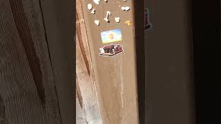 Gum along w/ sticker pictures placed onto the wooden wall under station Silver Bullet KBF, 8/25/2026