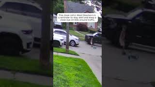Child on Scooter Nearly Struck by Oncoming Vehicle