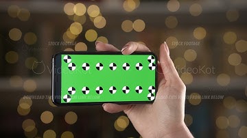 Mobile in horizontal orientation with tracking markers in woman hand against bokeh background