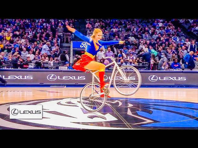 NBA Halftimeshow Dallas Mavericks - Viola Brand - Supergirl on Bike class=