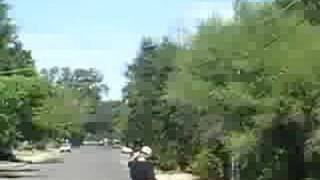 carl riding a longboard down a hill