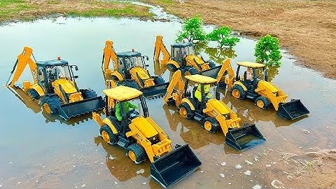 JCB 3dx Backhoe Mud Loading Trolley In Mahindra Arjun Two Tractor. And the river is being crossed.